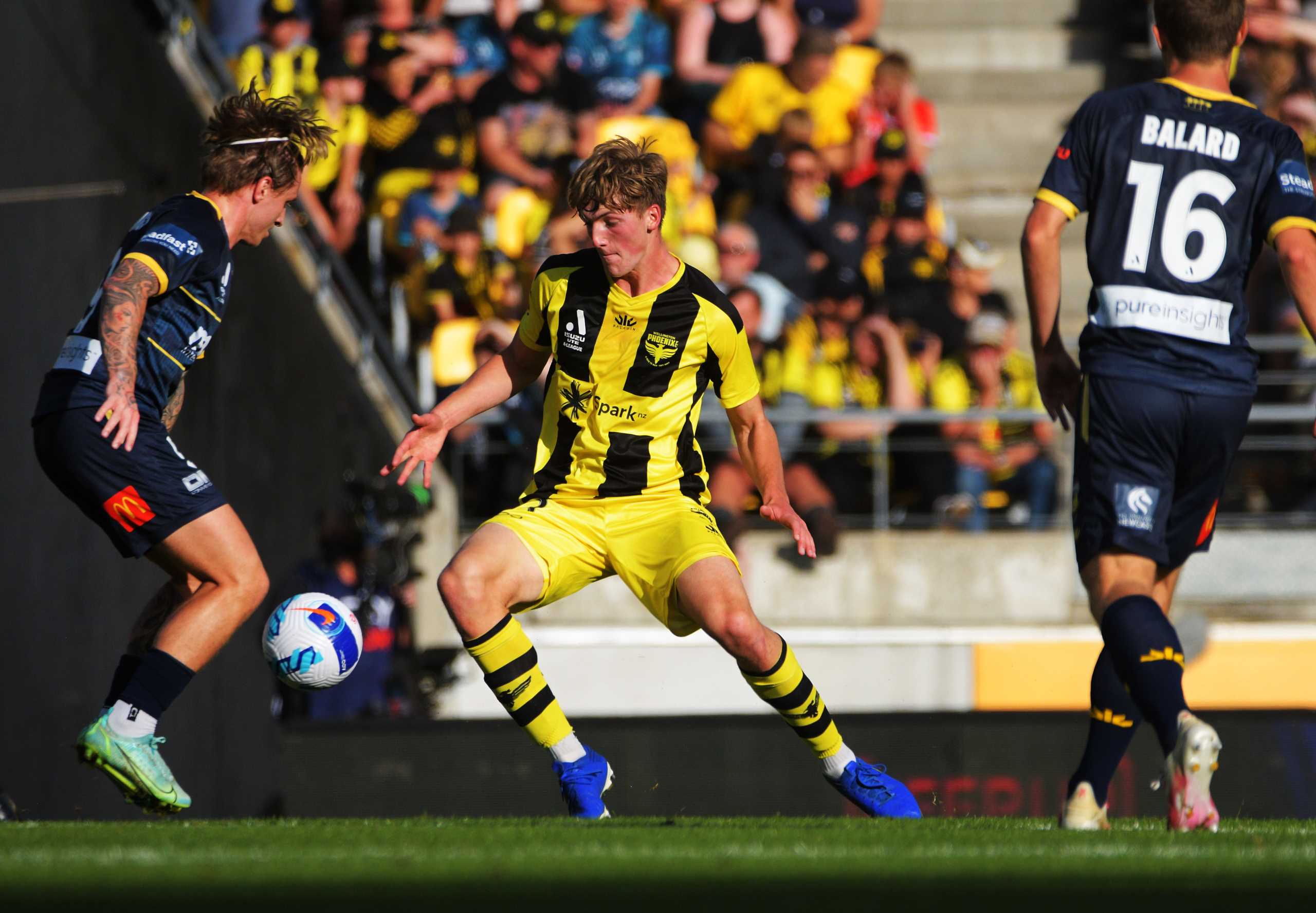 CCM's Jason Cummings (left) and Phoenix' Finn Surman compete for the ball during the A-League football match between Wellington Phoenix and Central Coast Mariners at Westpac Stadium in Wellington, New Zealand on Sunday, 17 April 2022. Photo: Dave Lintott / lintottphoto.co.nz