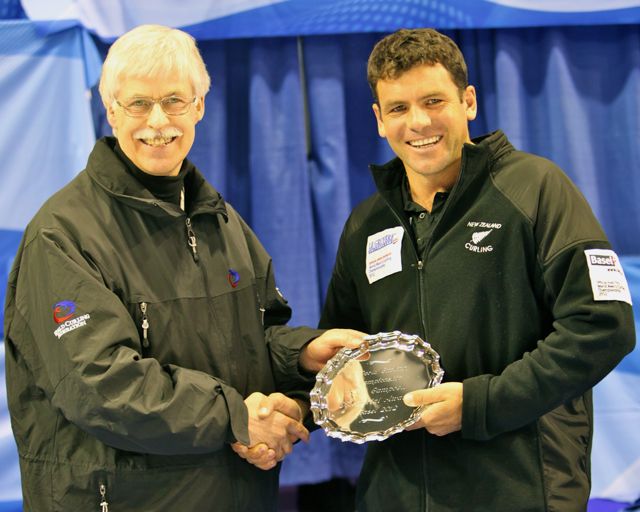 World Men's Curling Championship 2012 - Sean Becker presented with the Collie Campbell Award by Chief Umpire Alan Stanfield - Photo: Richard Gray / WCF